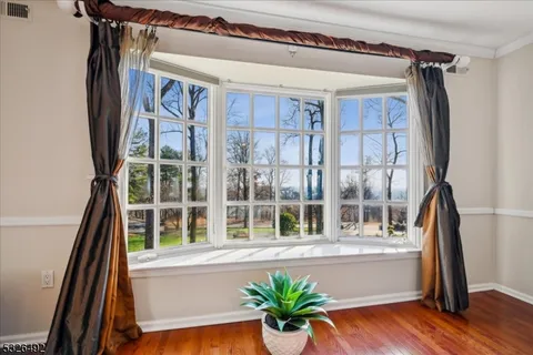 a view of balcony with furniture and wooden floor