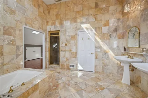 a view of a bathroom with bathtub and shower
