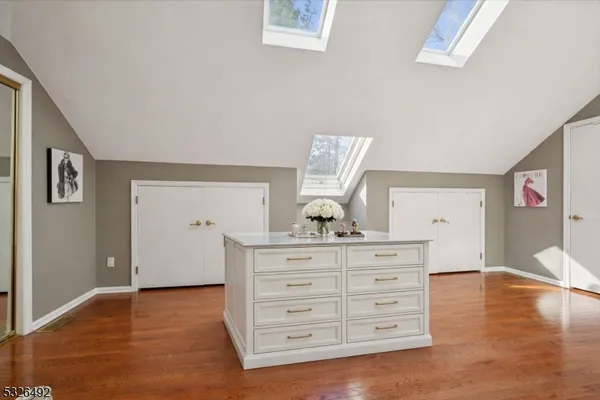 a view of a livingroom with a dresser wooden floor and cabinet