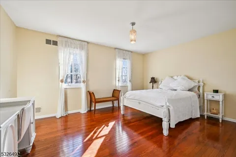 a spacious bedroom with a bed and a table in it