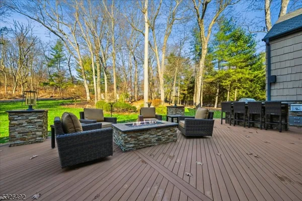 an outdoor sitting area with couch and wooden floor