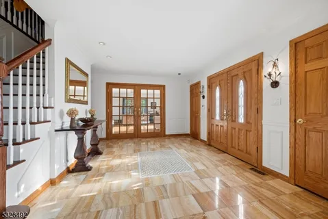 a view of hallway with furniture and a window