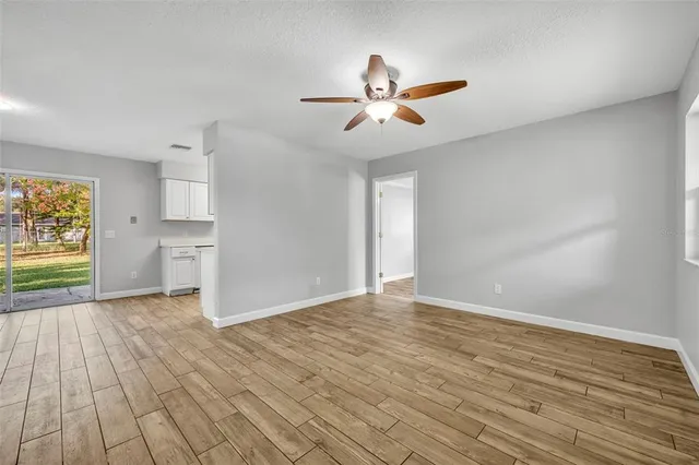 wooden floor in an empty room with a window