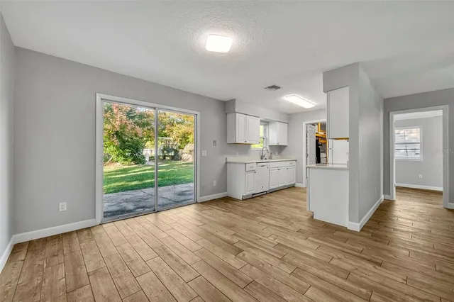 a view of a kitchen with wooden floor and a kitchen