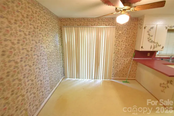 a view of a kitchen with fridge and workspace