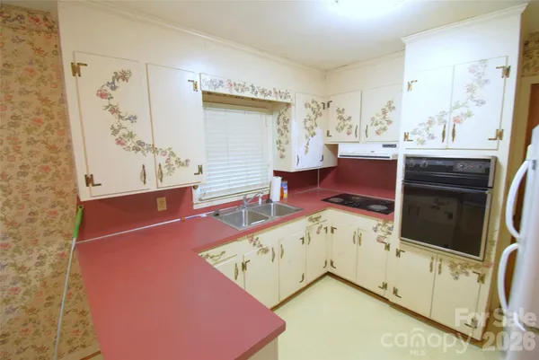 a living room with stainless steel appliances kitchen island granite countertop a stove a sink and a microwave