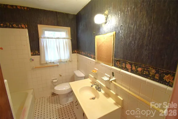 a bathroom with a bathtub sink and toilet