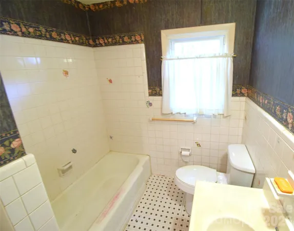 a bathroom with a sink a toilet and tub