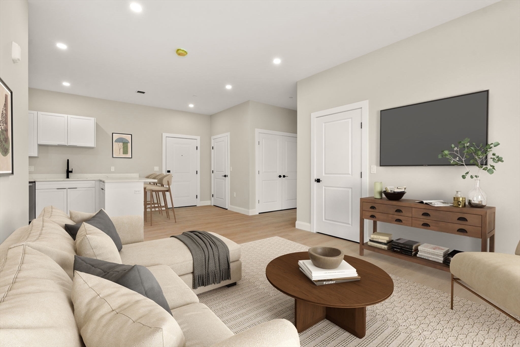 7 Cross Street, Unit 306 Wilmington, MA 01887 - Photo 2 of 14 a living room with furniture and a flat screen tv
