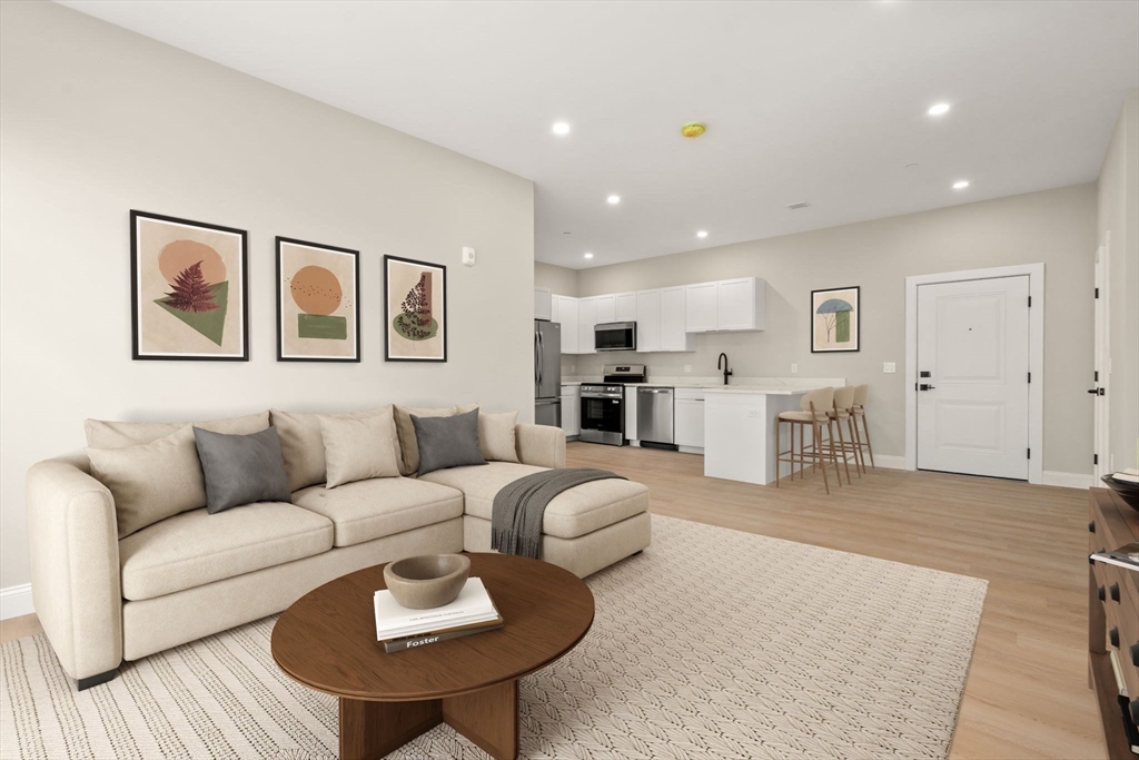 7 Cross Street, Unit 306 Wilmington, MA 01887 - Photo 3 of 14 a living room with furniture and kitchen view