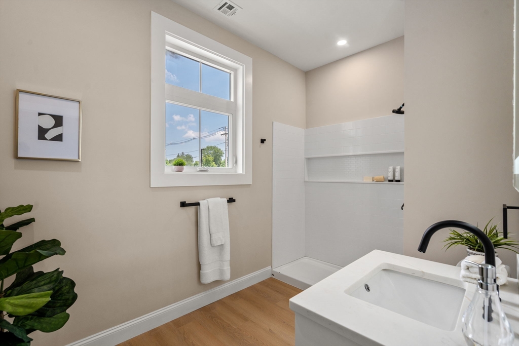 7 Cross Street, Unit 306 Wilmington, MA 01887 - Photo 6 of 14 a bathroom with a sink and a window