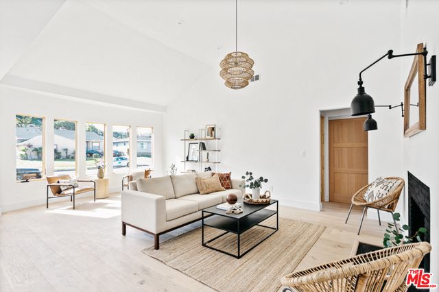 a living room with furniture wooden floor and a chandelier