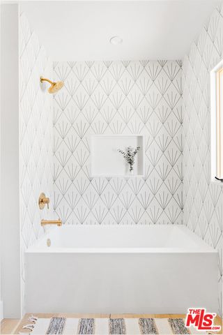 a bathroom with a bathtub and a shower