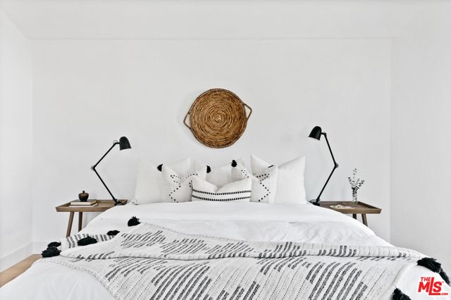 a bedroom with a bed and a potted plant