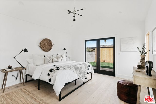 a bed room with a bed and a chandelier