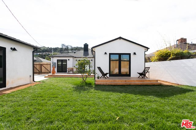 a view of a house with a backyard and a garden