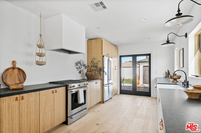a kitchen with a stove and a wooden floors