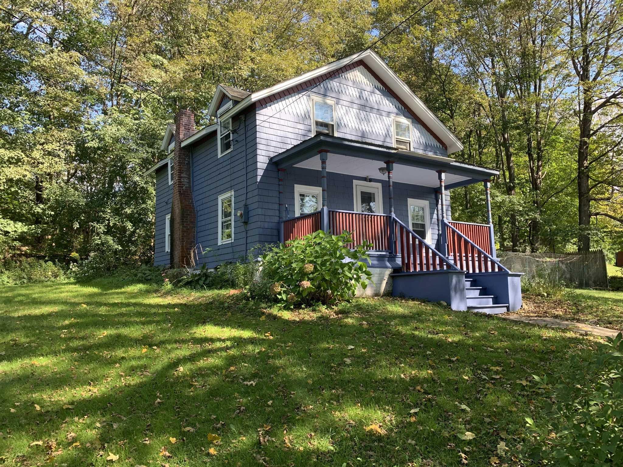 a view of a house with a yard and deck