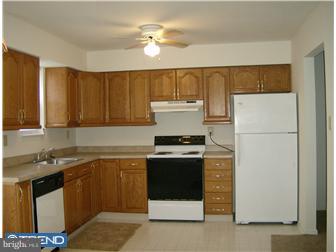 134 Hampshire Road Sicklerville, NJ 08081 - Photo 6 of 12 a kitchen with a sink a stove and refrigerator