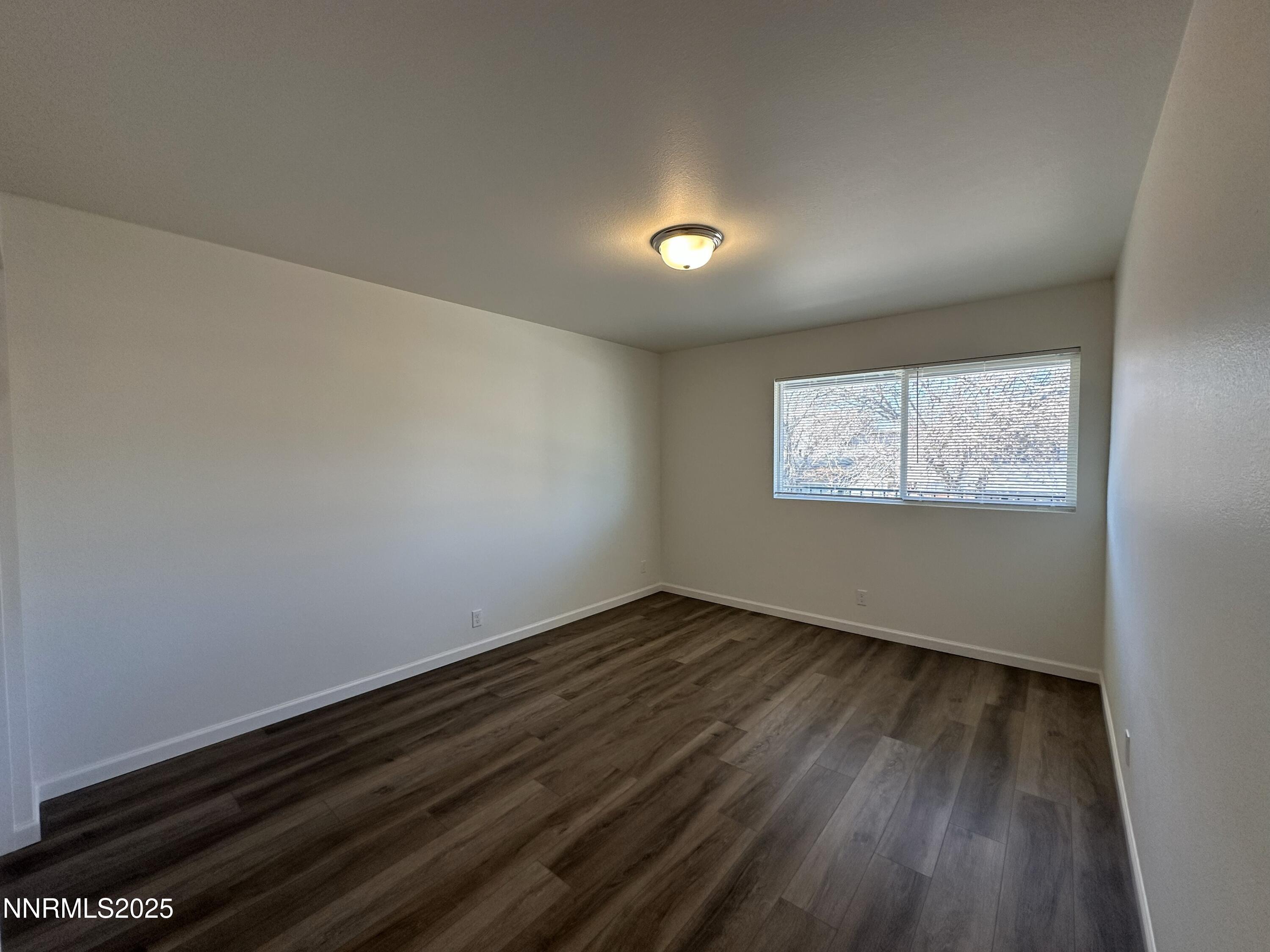 2380 Orange Lane Reno, NV 89502 - Photo 11 of 15 an empty room with wooden floor and windows