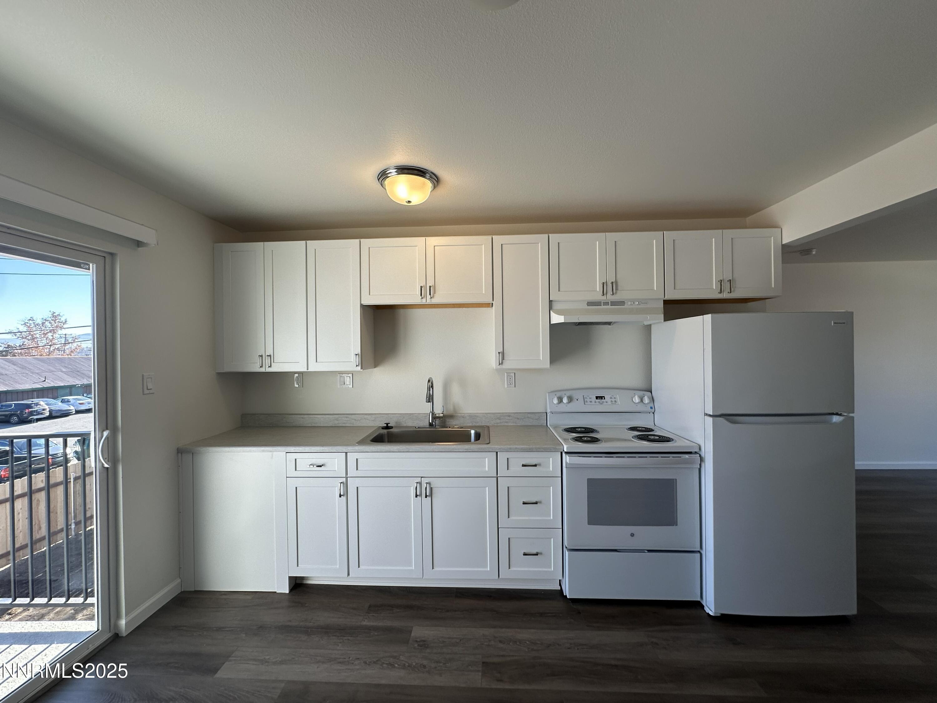 2380 Orange Lane Reno, NV 89502 - Photo 7 of 15 a kitchen with stainless steel appliances a sink a stove a refrigerator and cabinets