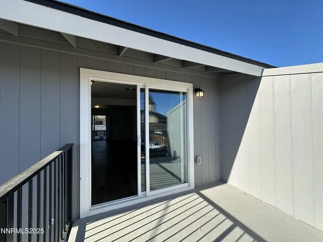 a view of a hallway with wooden floor and entryway