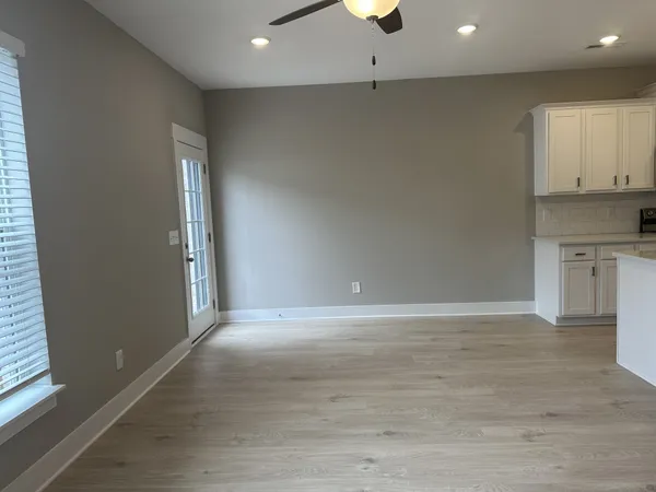 an empty room with wooden floor and a window