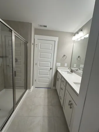 a bathroom with a double vanity sink a vanity and a mirror