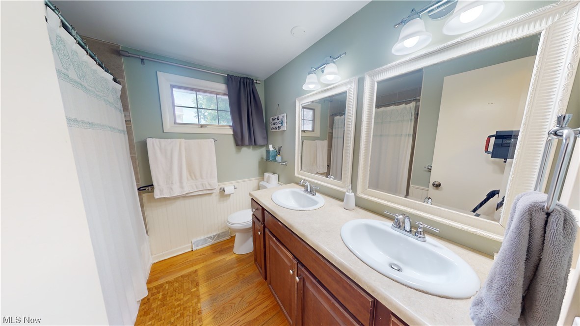 1071 Roland Road Lyndhurst, OH 44124 - Photo 18 of 30 Bathroom featuring light hardwood flooring, dual vanity, and mirror