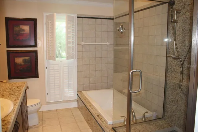 a bathroom with a shower a toilet and sink
