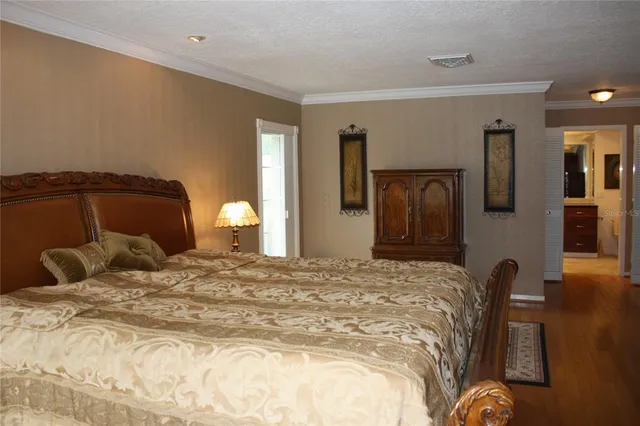 a bedroom with a bed and a lamp