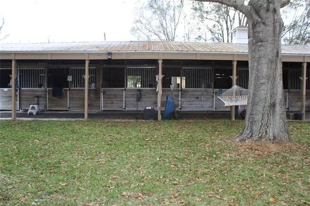 a view of a house with a backyard and porch