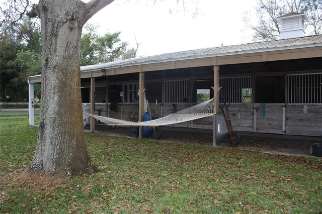 a backyard of a house with table and chairs