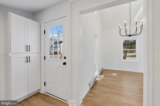 a view of a livingroom with wooden floor and white walls