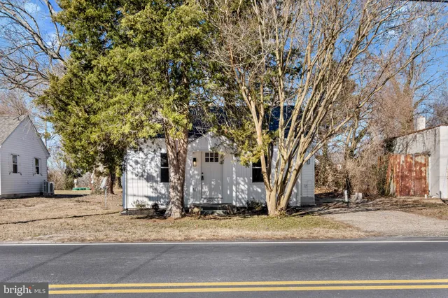 a view of a road with a house in the background