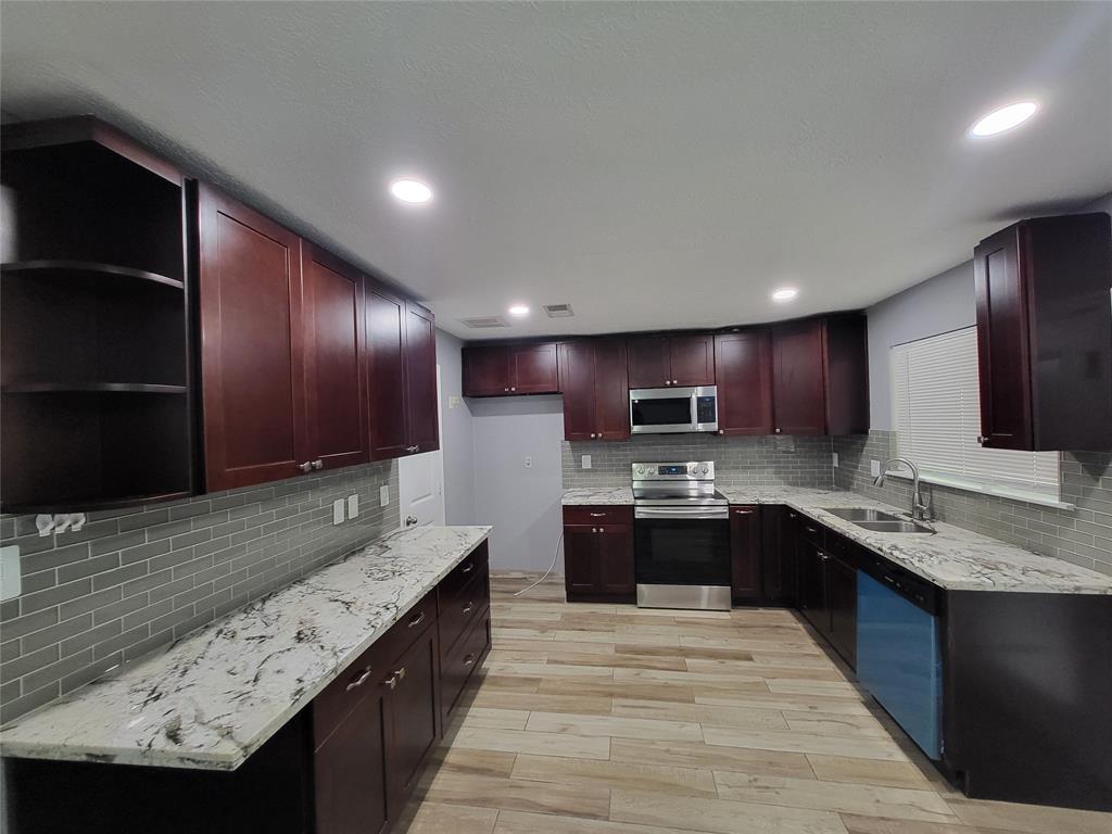 a large kitchen with granite countertop lots of counter top space