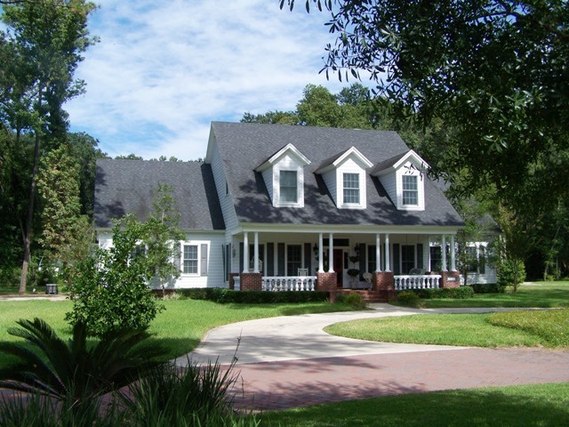 a front view of a house with a yard table and chairs