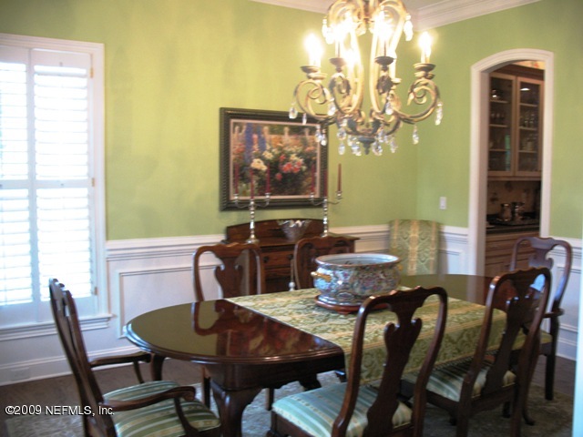 12142 Mandarin Road Jacksonville, FL 32223 - Photo 12 of 50 a view of a dining room with furniture and chandelier