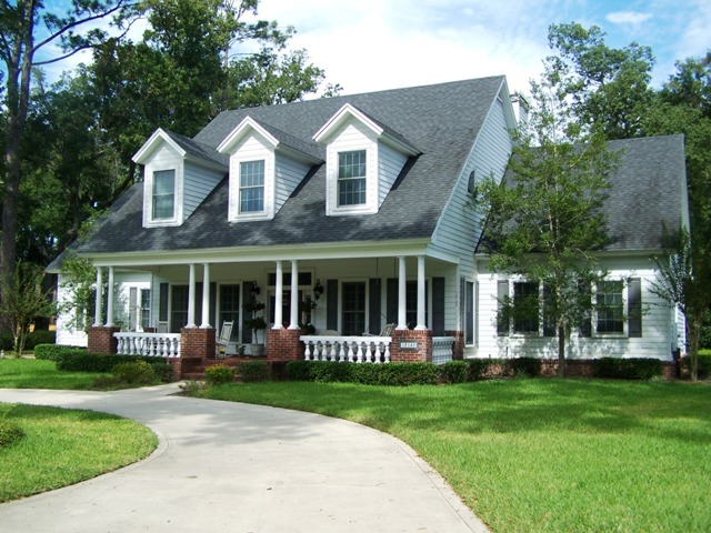 12142 Mandarin Road Jacksonville, FL 32223 - Photo 5 of 50 a front view of a house with a yard table and chairs