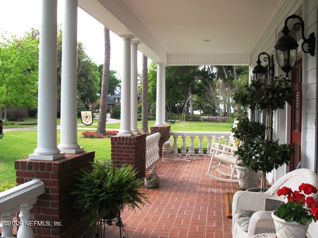 12142 Mandarin Road Jacksonville, FL 32223 - Photo 7 of 50 a view of a patio with couches table and chairs and potted plants