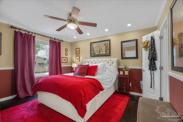 a bedroom with a large bed and a window