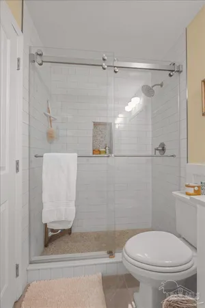 a bathroom with a toilet and a shower