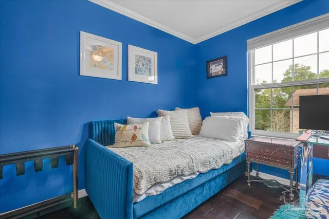 a living room with a bed furniture and a window
