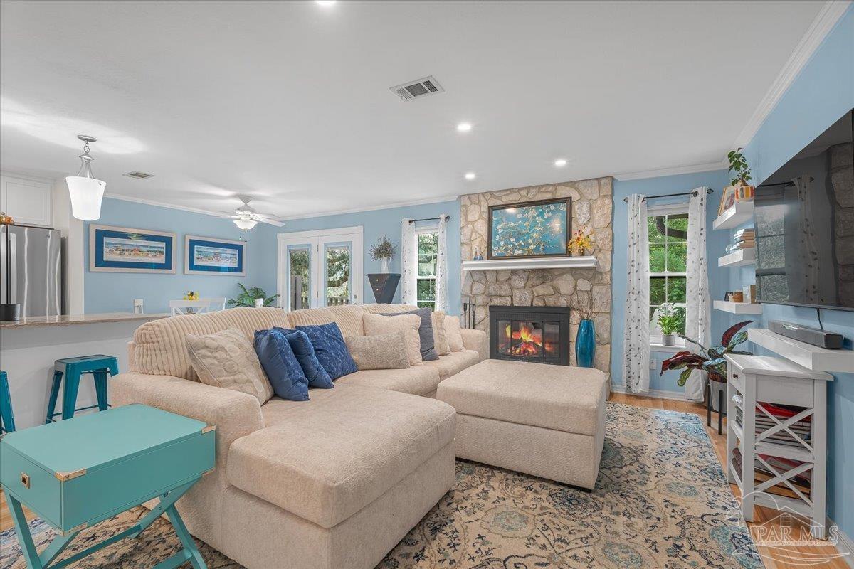 4831 East Olive Road, Unit 1D Pensacola, FL 32514 - Photo 2 of 36 a living room with furniture and a fireplace
