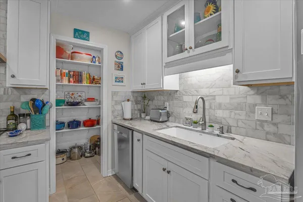 a kitchen with a sink dishwasher and cabinets