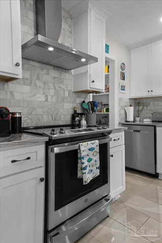 a kitchen with stainless steel appliances a stove and cabinets