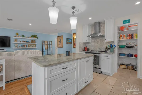 a kitchen with stainless steel appliances granite countertop a sink and a refrigerator