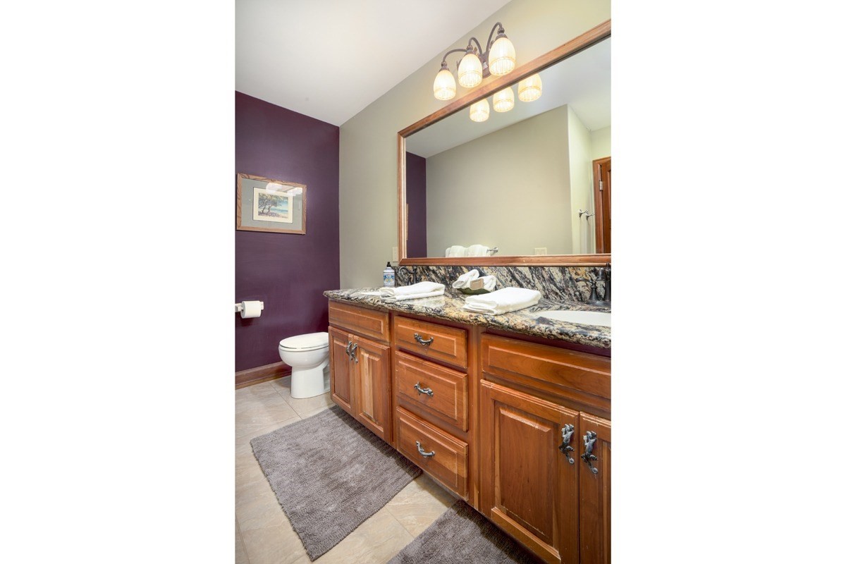 1871 Pe'e Road, Unit 2 Koloa, HI 96756 - Photo 11 of 25 a bathroom with a sink a toilet and mirror