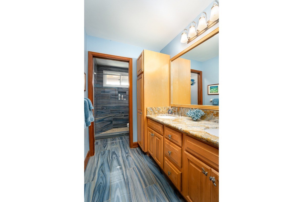 1871 Pe'e Road, Unit 2 Koloa, HI 96756 - Photo 15 of 25 a bathroom with a sink and a mirror