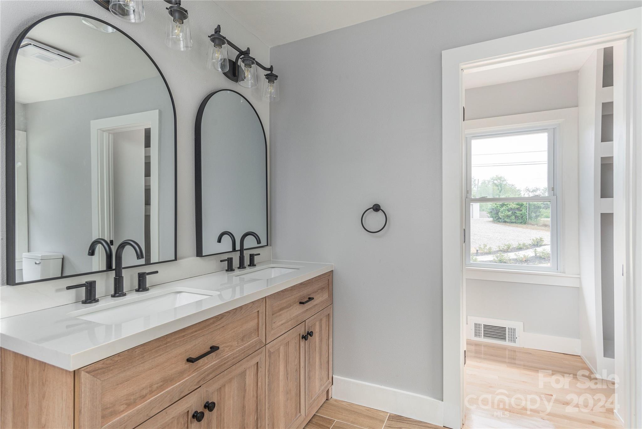1045 North Canton Road Canton, NC 28716 - Photo 13 of 26 a bathroom with a granite countertop sink a mirror and a